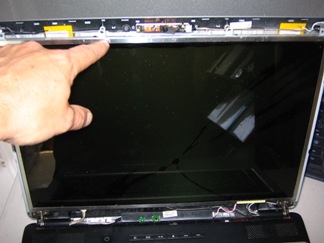 Undo the screws holding the LCD panel to the notebook case